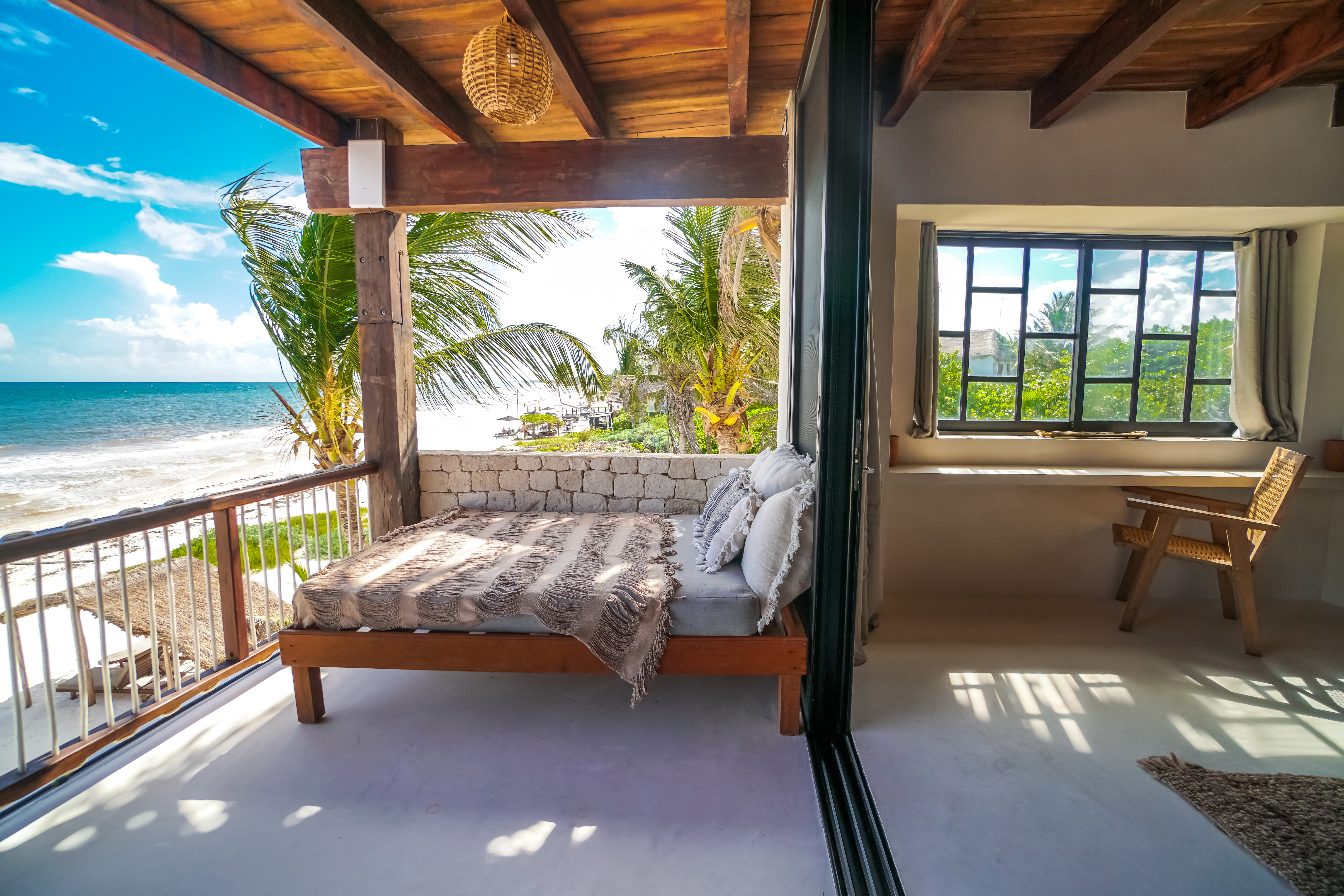 Woman journaling by the ocean with palm trees