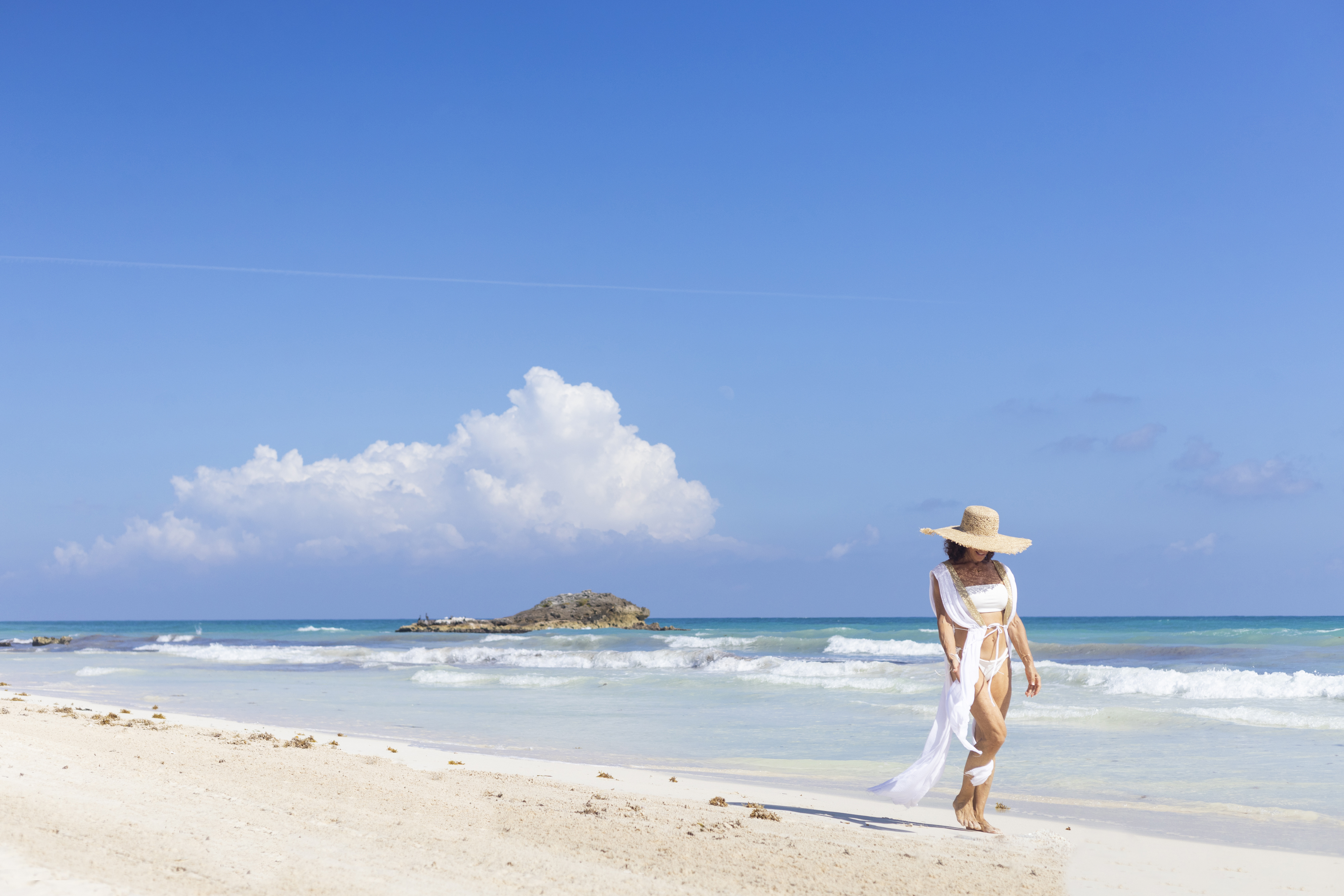 Woman walking on the beach in Tulum