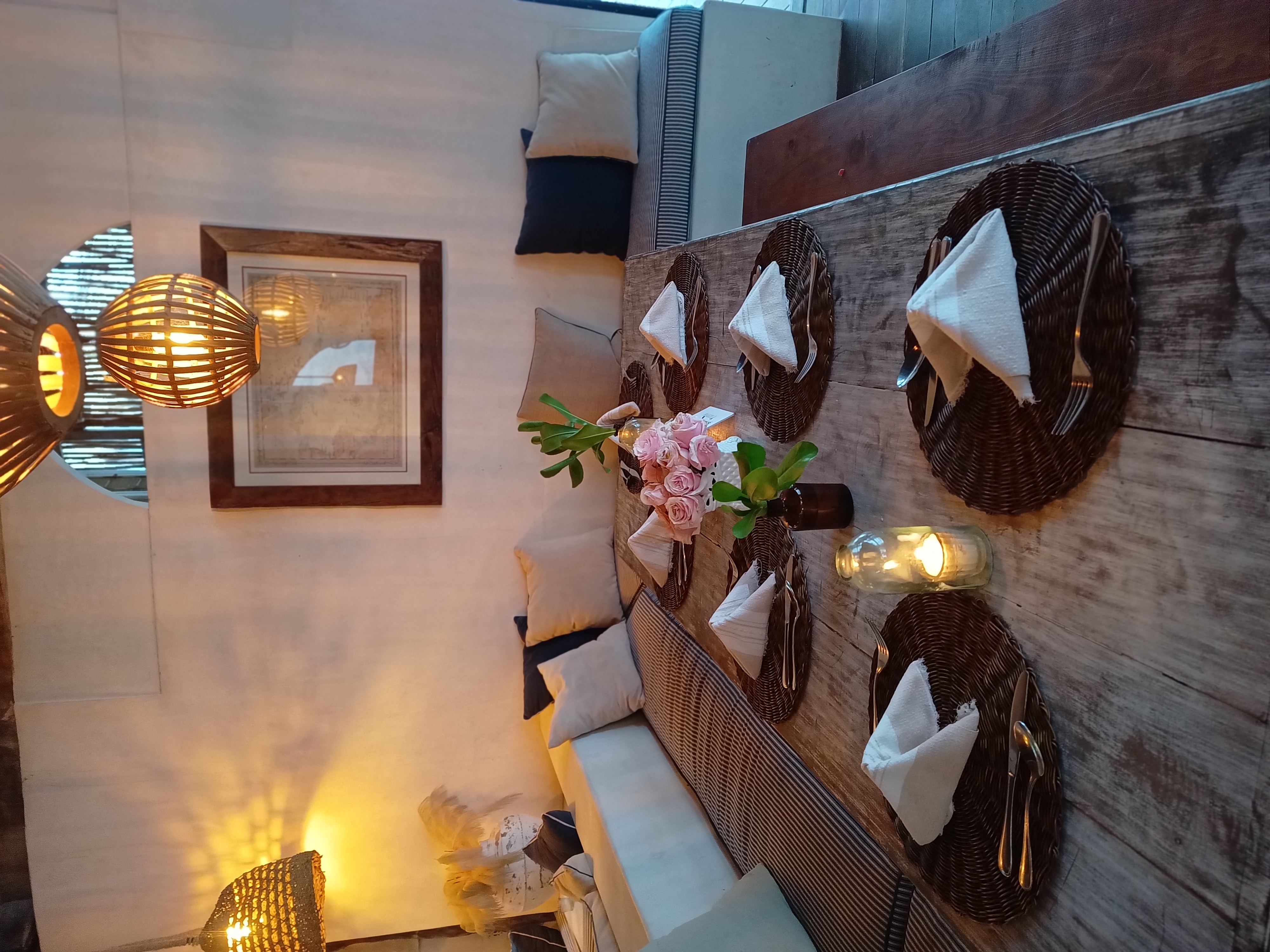 Candlelit dinner table with roses at Amansala