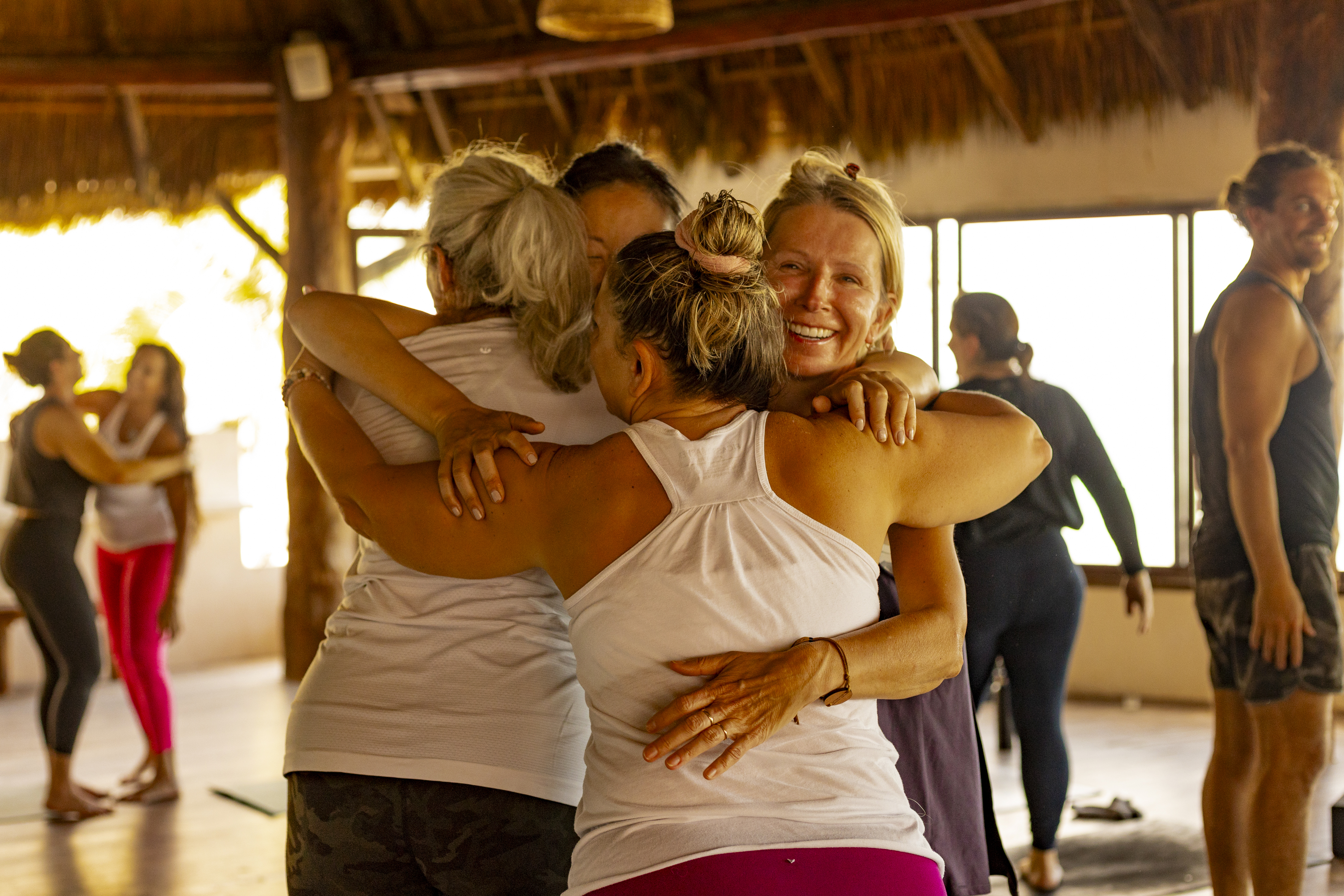 Women embracing during a retreat at Amansala