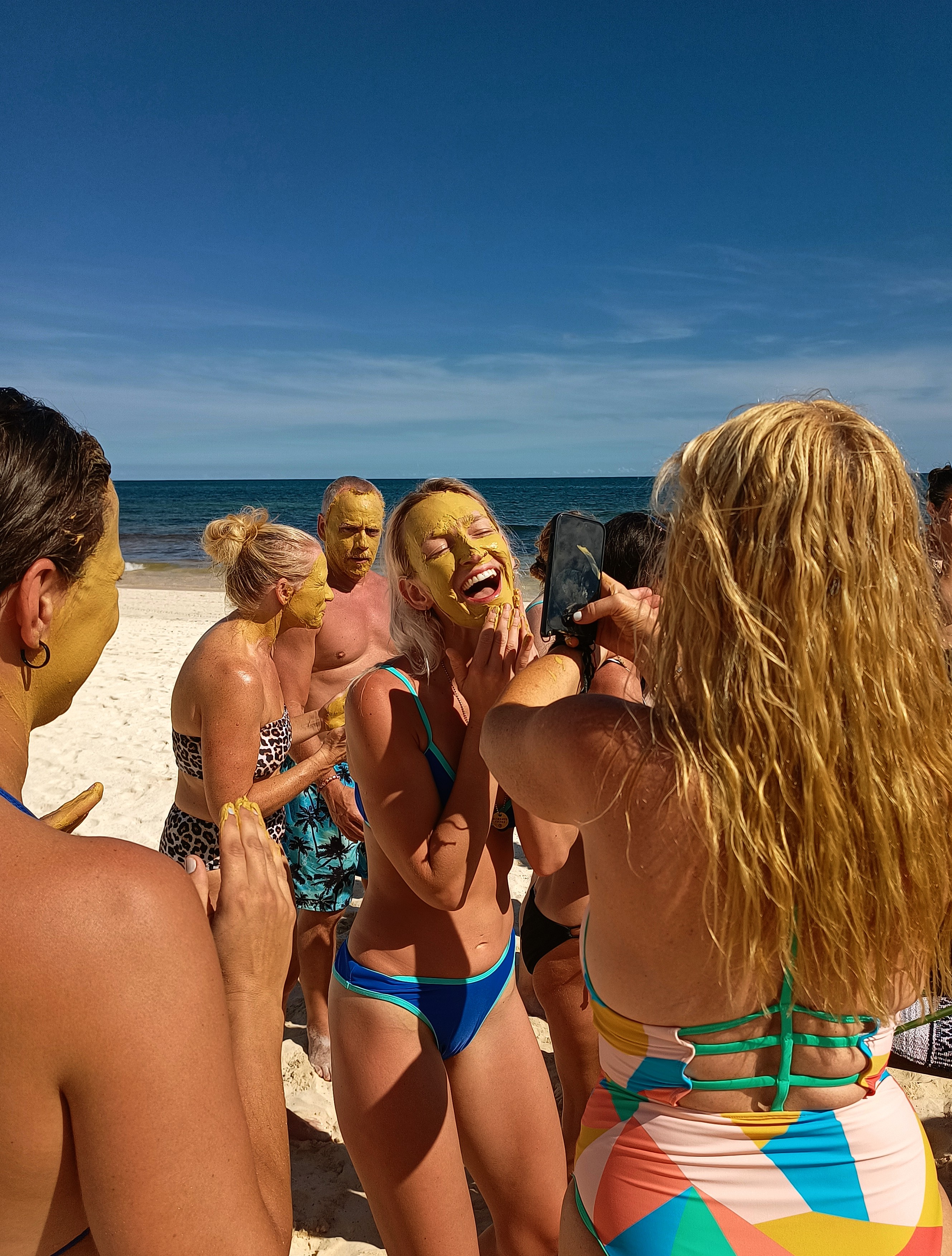 Group of women laughing together on the beach